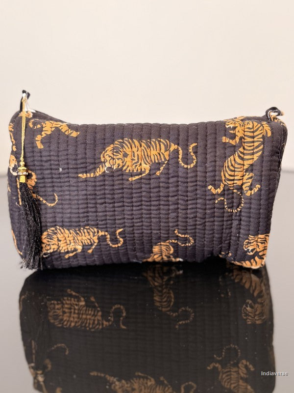 black pouch with tiger print sitting on a glass surface