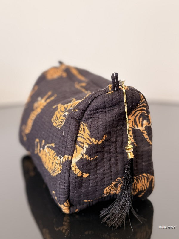 black pouch with black tassel and tiger print on smooth surface