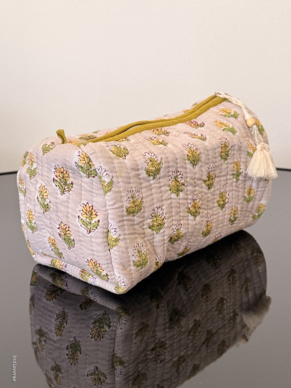 Two patterned bags, one with a floral design and the other with a solid color, on a plain background.