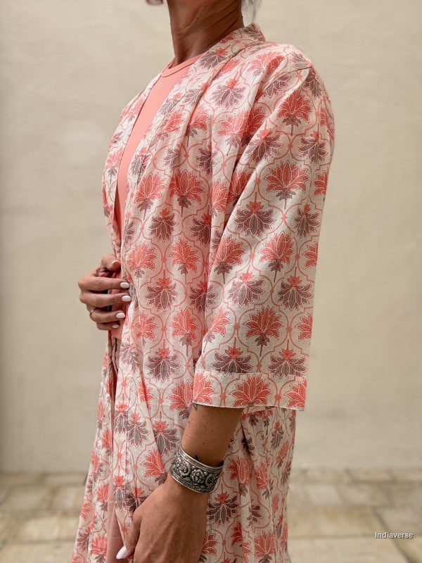 close up of a woman wearing a midi size kimono with orange lotus print 
