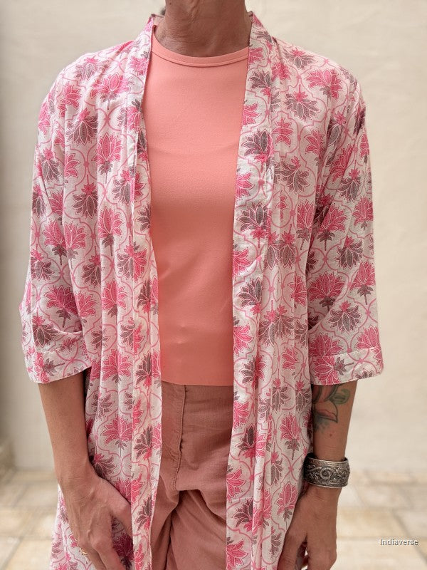 close up of the front of a woman wearing a midi size kimono with orange lotus print