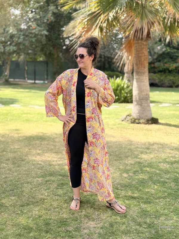 Woman wearing a colorful floral kimono in a park setting