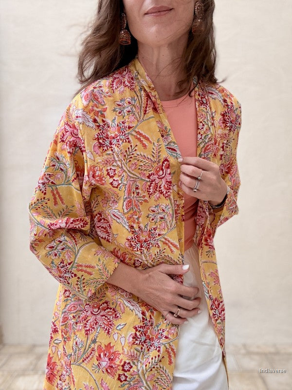 close up of a woman wearing a long abaya robe with floral design