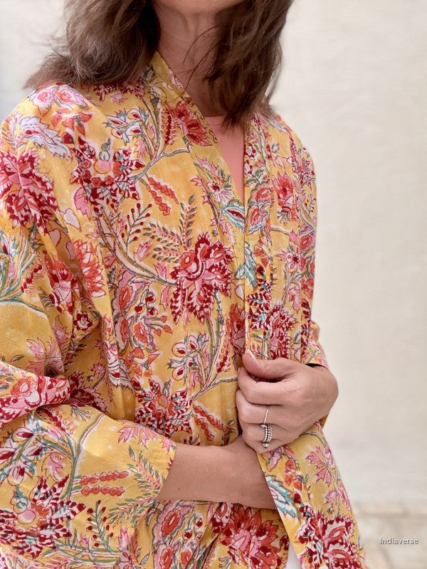 close up of a long yellow robe with red and blue floral design