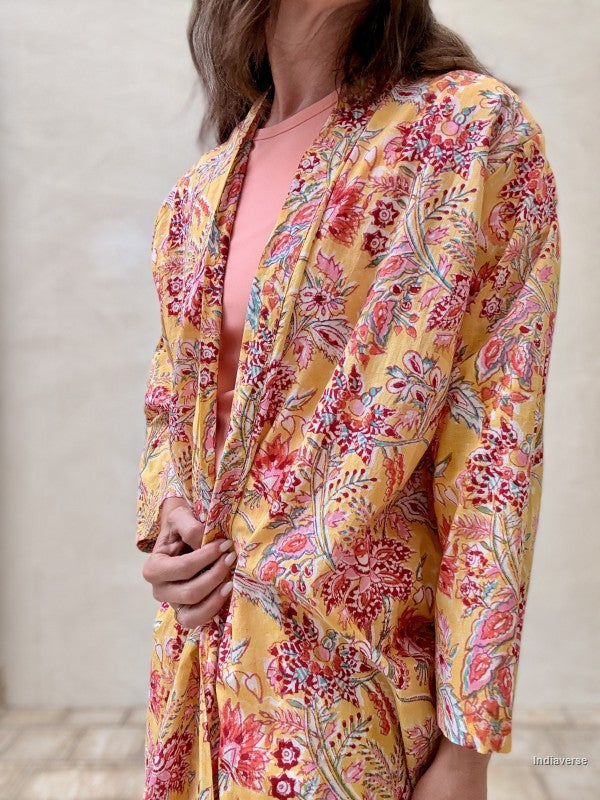 close up of a yellow long abaya robe with floral design