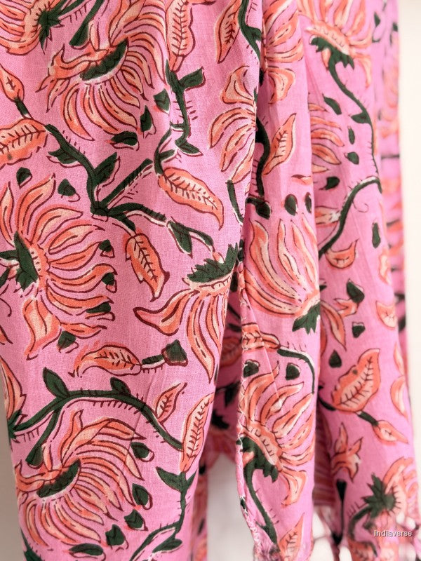 close up of a pink cotton scarf with orange flower design