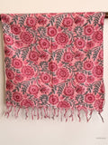 cotton scarf with pink flower design hanging from a wooden beam