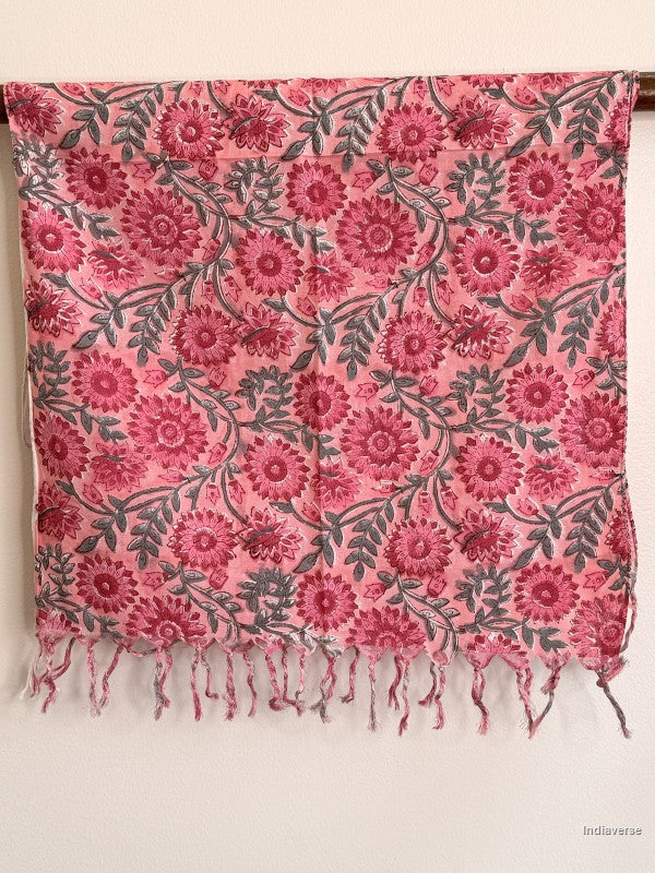 cotton scarf with pink flower design hanging from a wooden beam