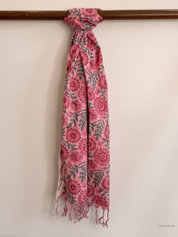 pink cotton scarf with floral design tied to a wooden beam