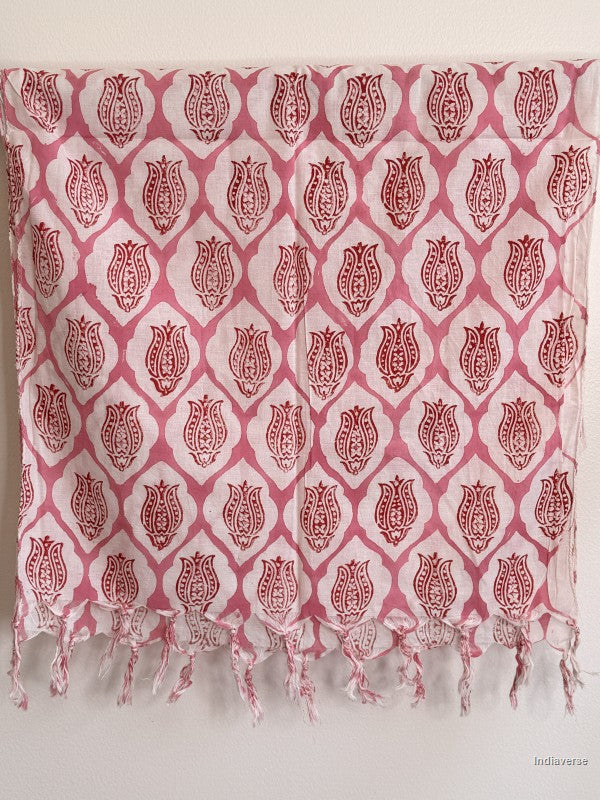 pink cotton scarf with geometric lotus design hanging from a wooden beam