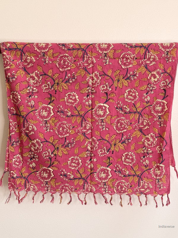 cotton scarf with pink rose design hanging from a wooden beam