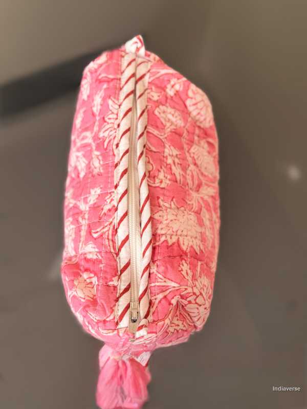 Pink floral-patterned pouch with a zipper on a dark background | Pink Delight