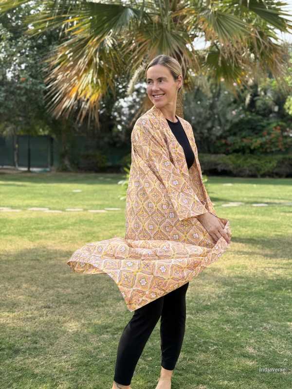 Woman wearing a patterned beige scarf in a park setting