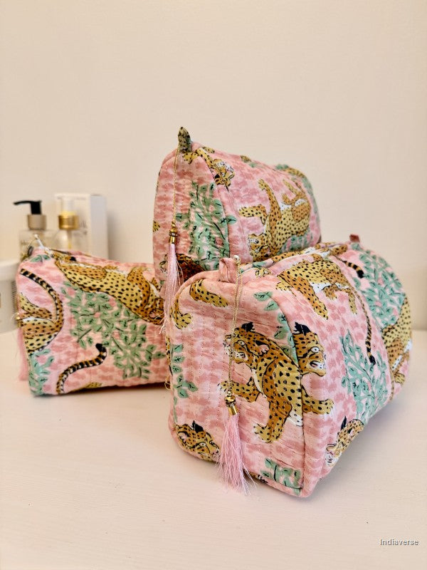 Three fabric cosmetic pouches in a matching pink leopard print set, arranged on a white surface against a light beige background | Rose Leopard