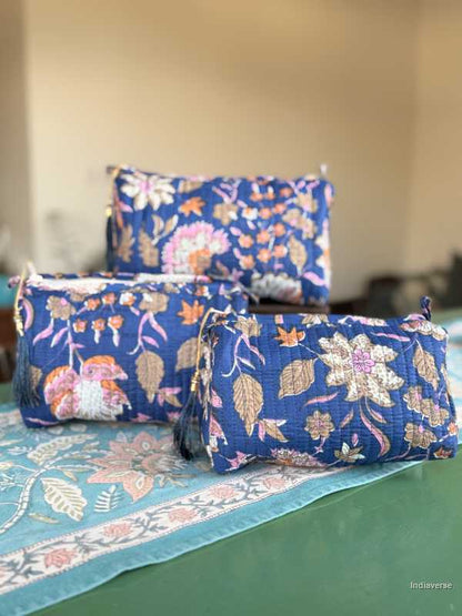 Set of blue floral-patterned bags on a green surface with a blurred background | Royal Blue