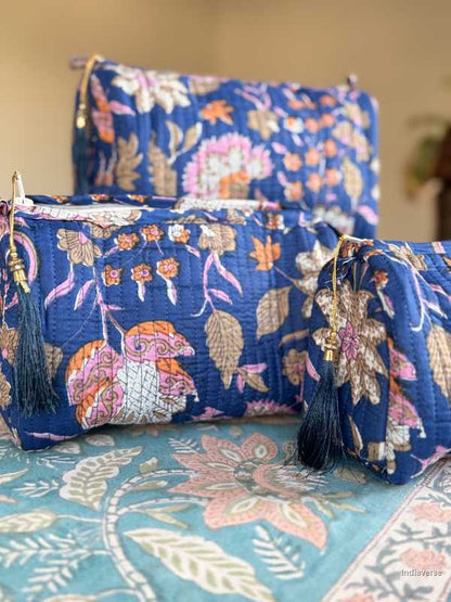 Three blue floral pouches with tassels on a textured surface | Royal Blue