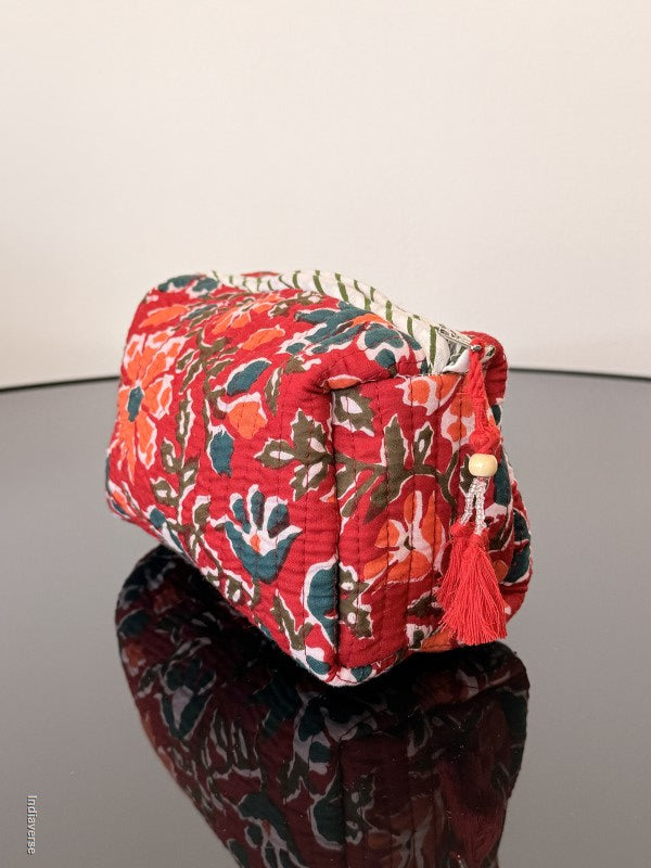 Red floral-patterned fabric roll on a white background