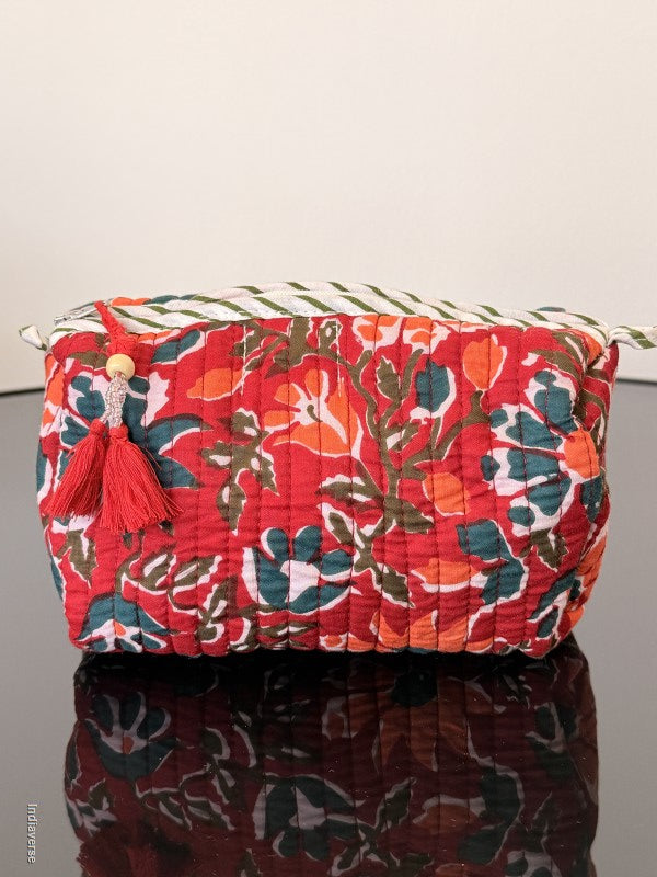 Two floral-patterned bags, one red and one maroon, against a light background.