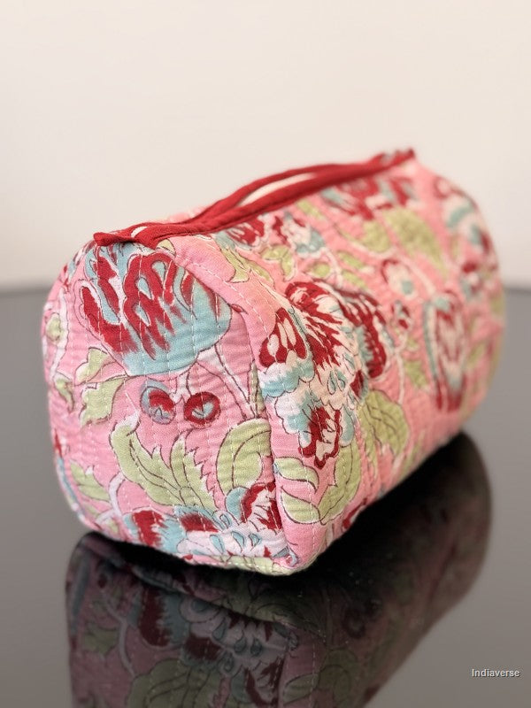 toiletry bag with floral design sitting on a glass surface