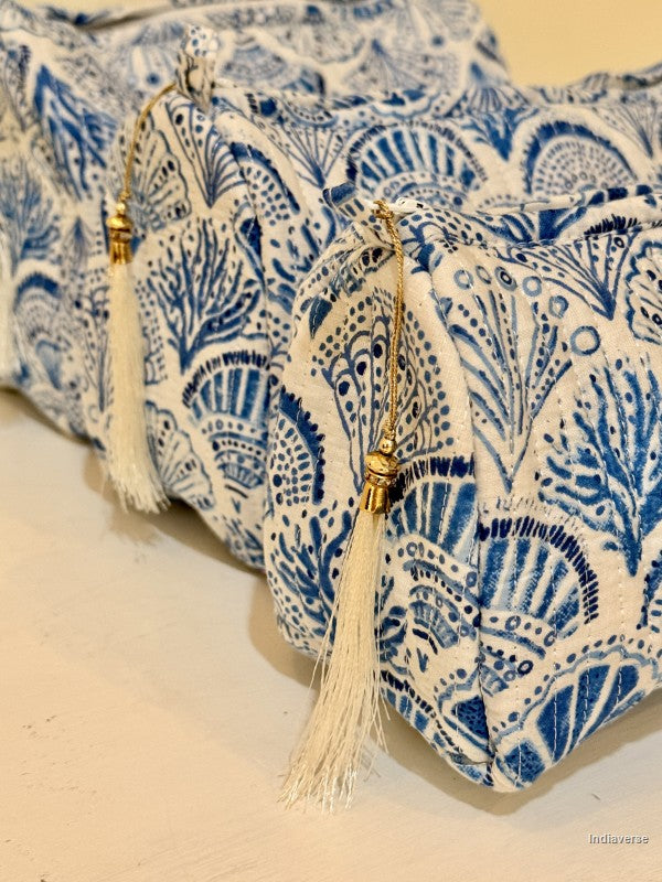 Close up of toiletry pouch set of three pieces with blue coral and sea shell design on white and with white tassels | Blue Sea Shells