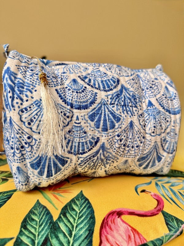 One toiletry pouch set sitting on a yellow colorful table with blue coral and sea shell design on white | Blue Sea Shells