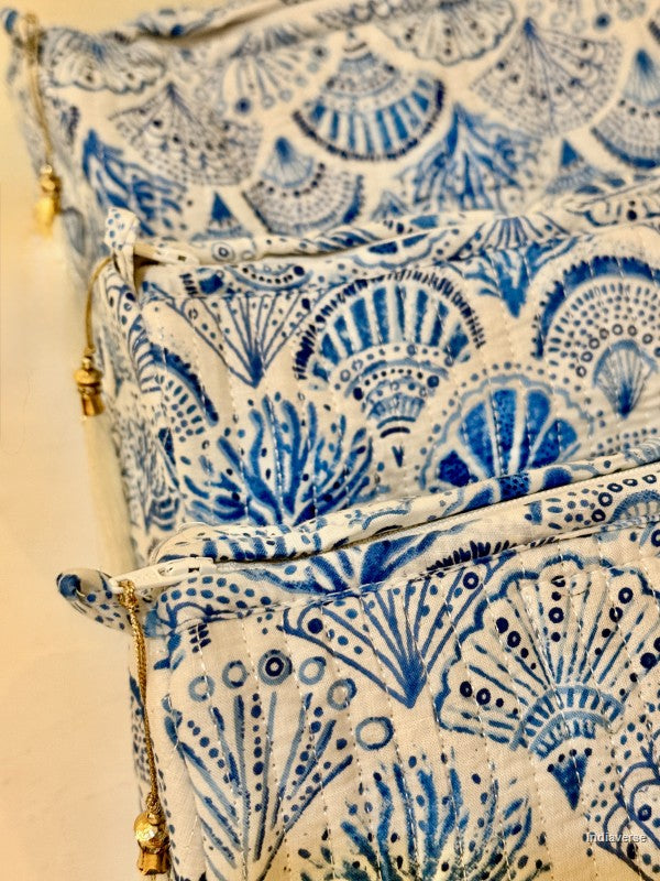 Close up of toiletry pouch set of three pieces with blue coral and sea shell design on white | Blue Sea Shells
