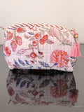Toiletry bag with nice floral pattern sitting on a glass surface