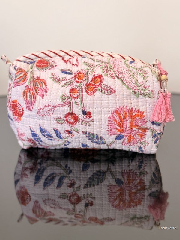 Toiletry bag with nice floral pattern sitting on a glass surface