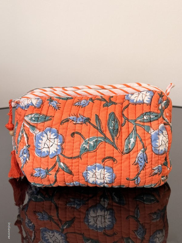 Floral-patterned fabric with orange background on a plain background