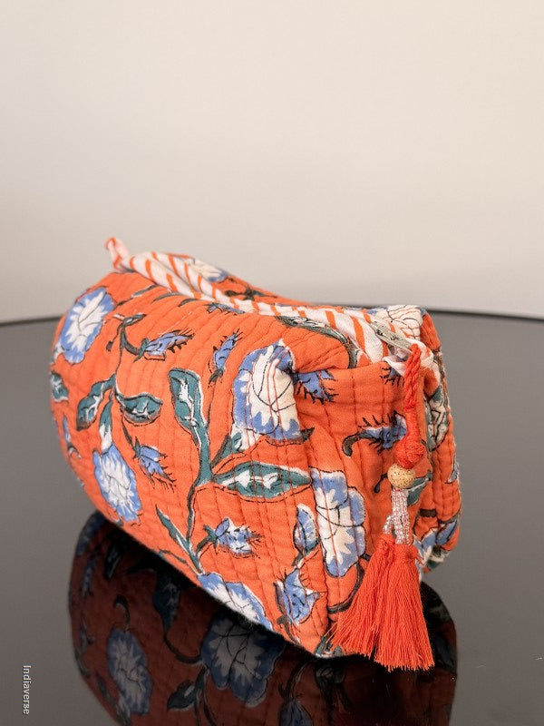 Floral-patterned fabric with orange background on a gray surface