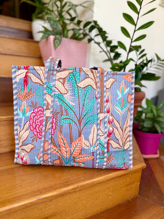 large cotton tote bag with tropical leaf design in turquoise, orange and cream colors perfect for carrying to the beach and shopping