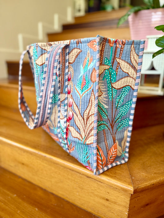 large cotton tote bag with tropical leaf design in turquoise, orange and cream colors perfect for carrying to the beach and shopping