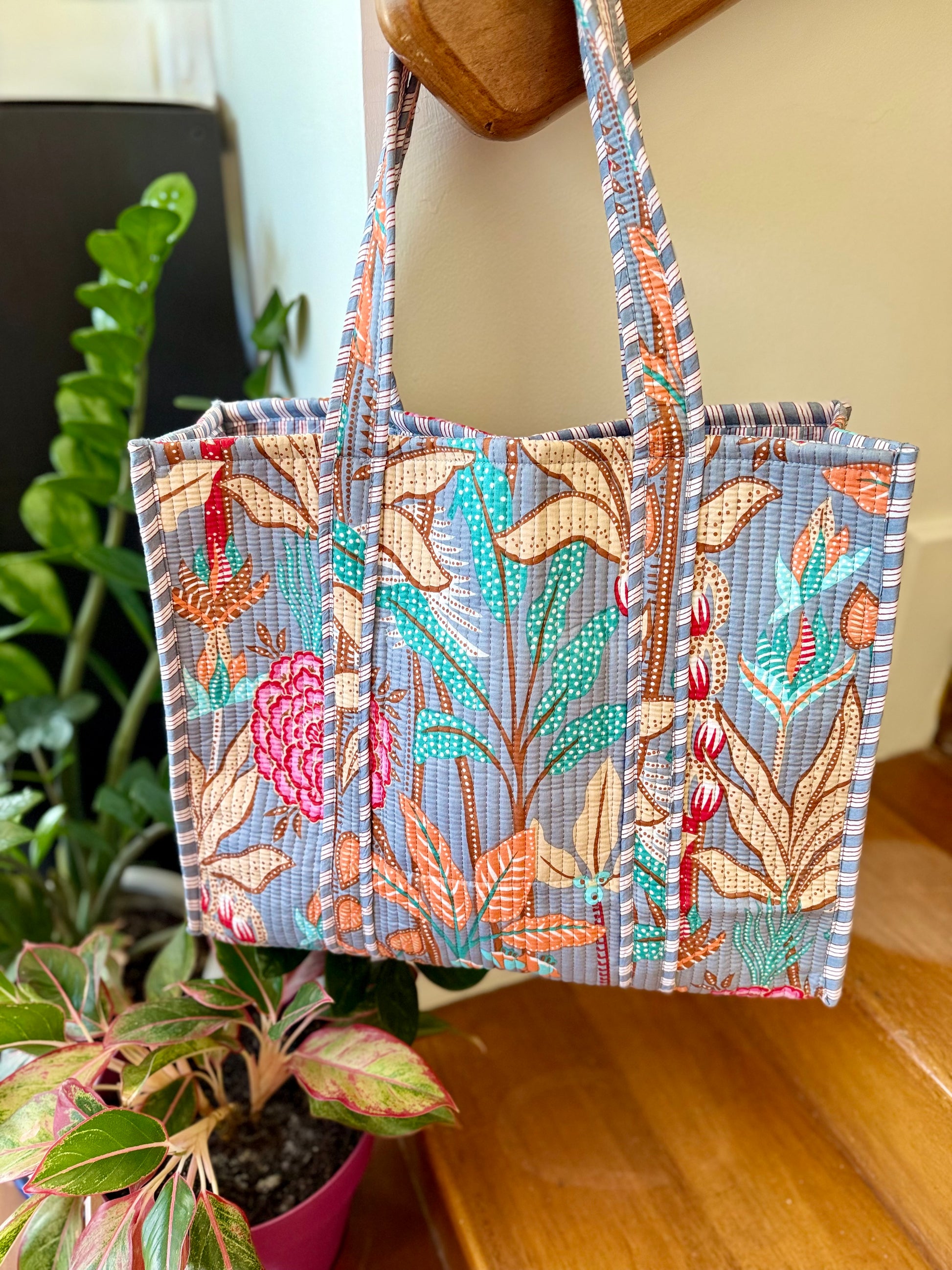 large cotton tote bag with tropical leaf design in turquoise, orange and cream colors perfect for carrying to the beach and shopping