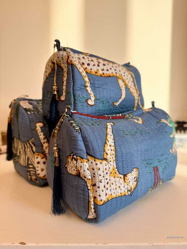 Blue quilted bag with animal print accents on a light background set of three blue pouches with animal theme print | Tropical Jungle