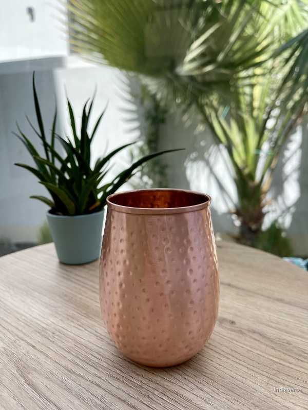 polished copper cup with hammered details made for serving water and healthy alternative to glass