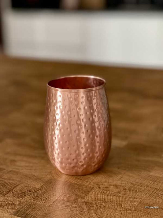 polished copper cup with hammered details made for serving water and healthy alternative to glass