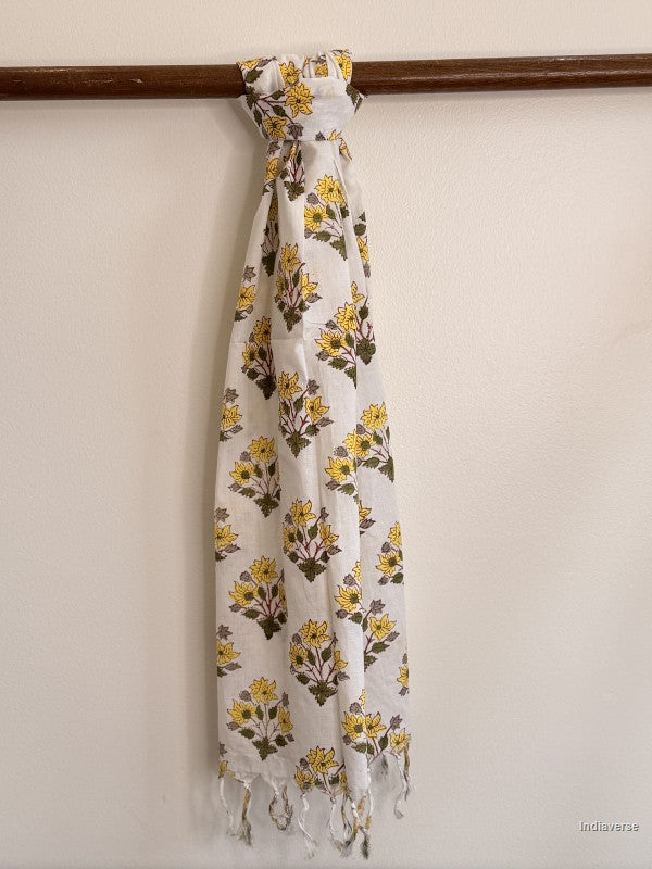 cotton scarf with yellow flower design tied to a wooden beam