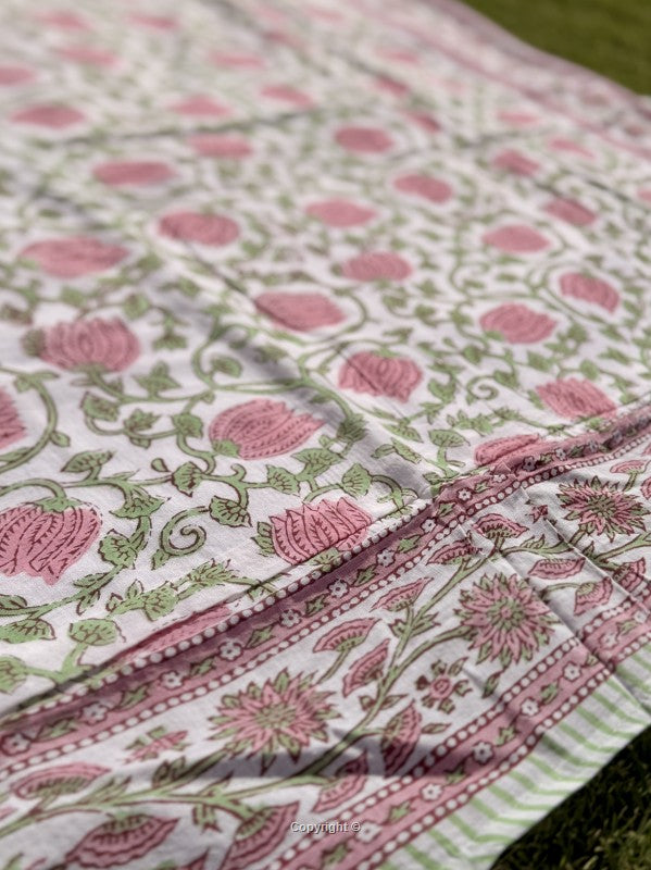 Floral patterned fabric with pink and green colors on a white background