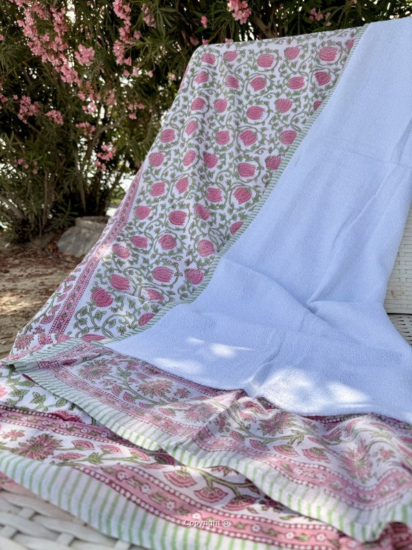 Floral patterned fabric draped over a chair with a garden background