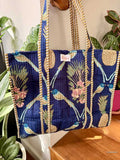 tropical royal blue tote bag with bird and pineapple design hanging