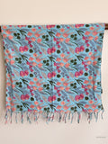 blue cotton scarf with floral design hanging over a wooden beam