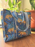 Blue bag with leopard pattern on a wooden surface