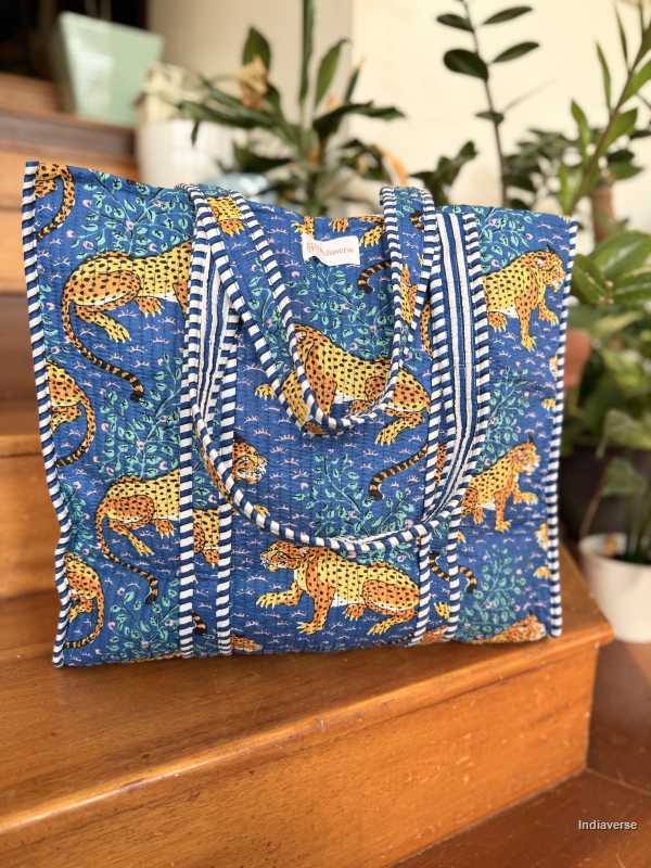 Blue tote bag with leopard pattern on a wooden surface