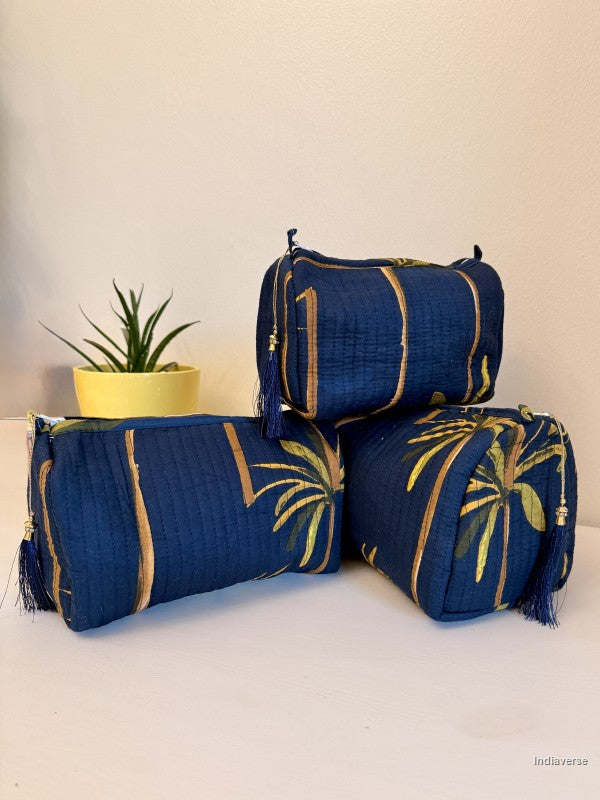 Set of three blue pouches with palm tree designs on a white surface | Blue Palm