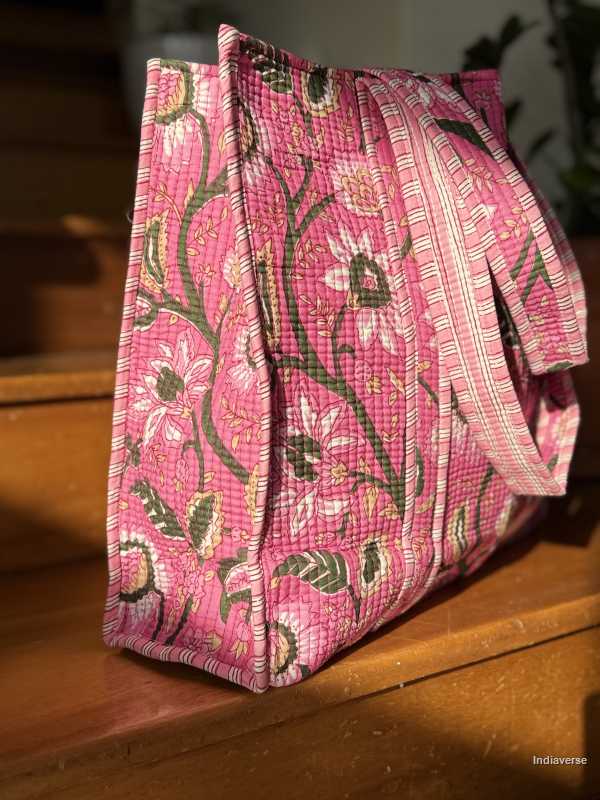 Pink floral patterned tote bag on a wooden surface