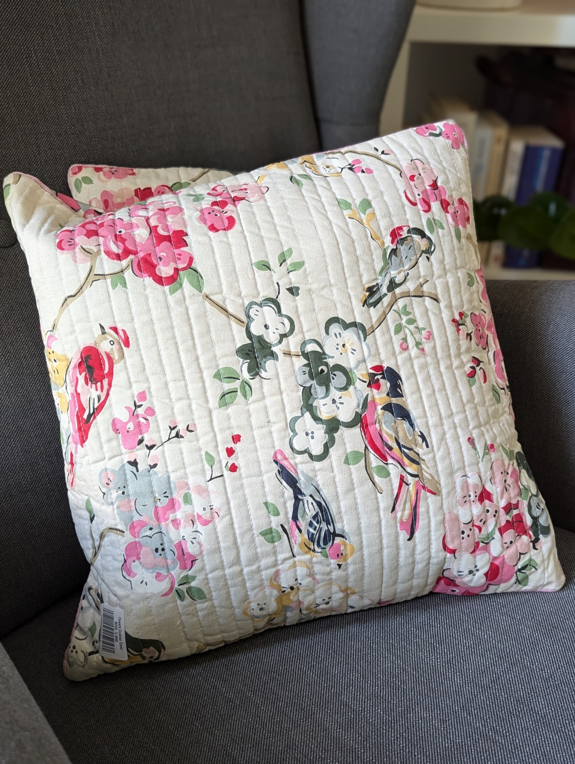 Cushion-cover-with-a-cream-base-and-with-colorful-birds-and -flower-blossom-design