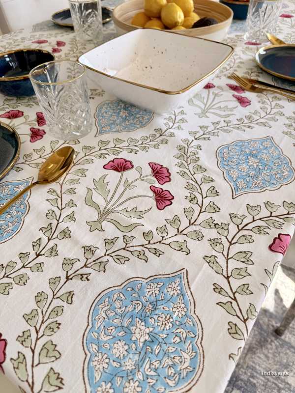 Decorative tablecloth with floral and geometric patterns on a table setting.