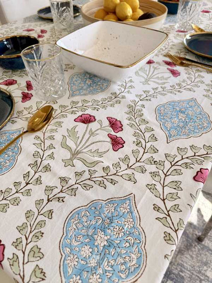 Decorative tablecloth with floral and geometric patterns on a table setting.