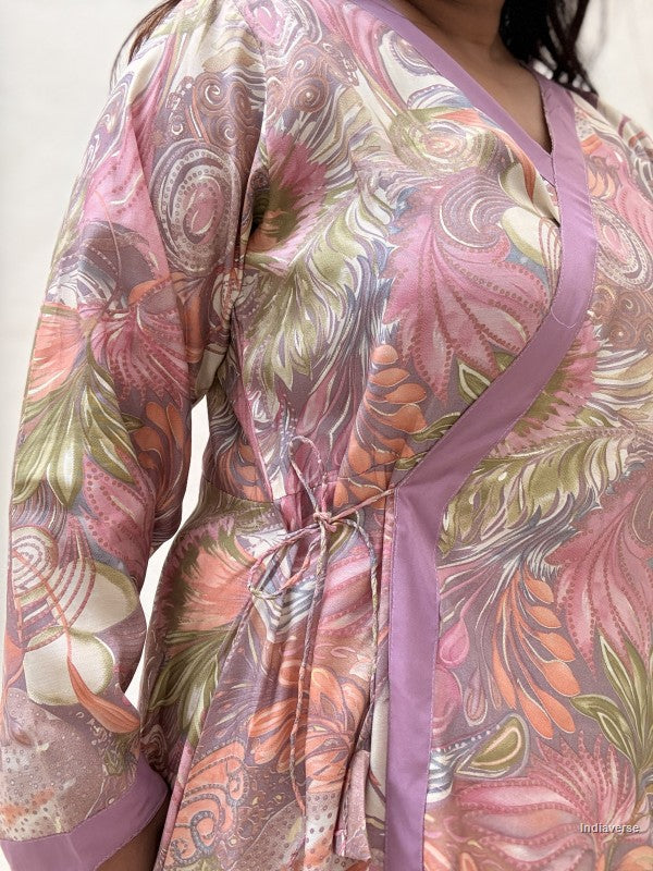 Floral patterned robe with a belt on a plain background