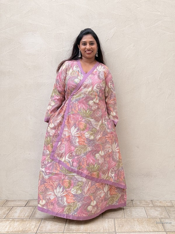 Woman wearing a floral dress with a plain background